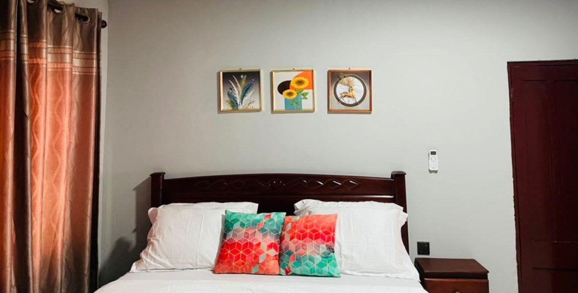 Bedroom with framed wall art and a bedside table