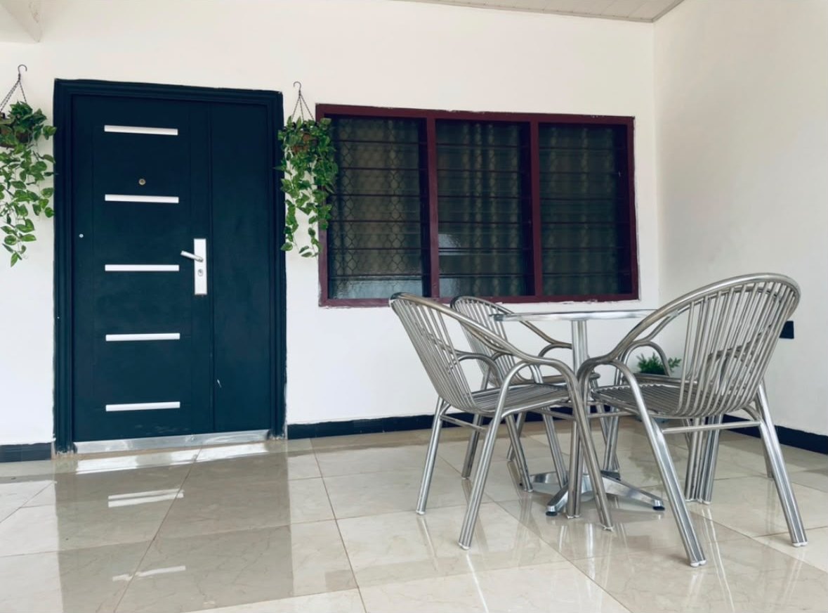 Covered porch with an outdoor table and chairs